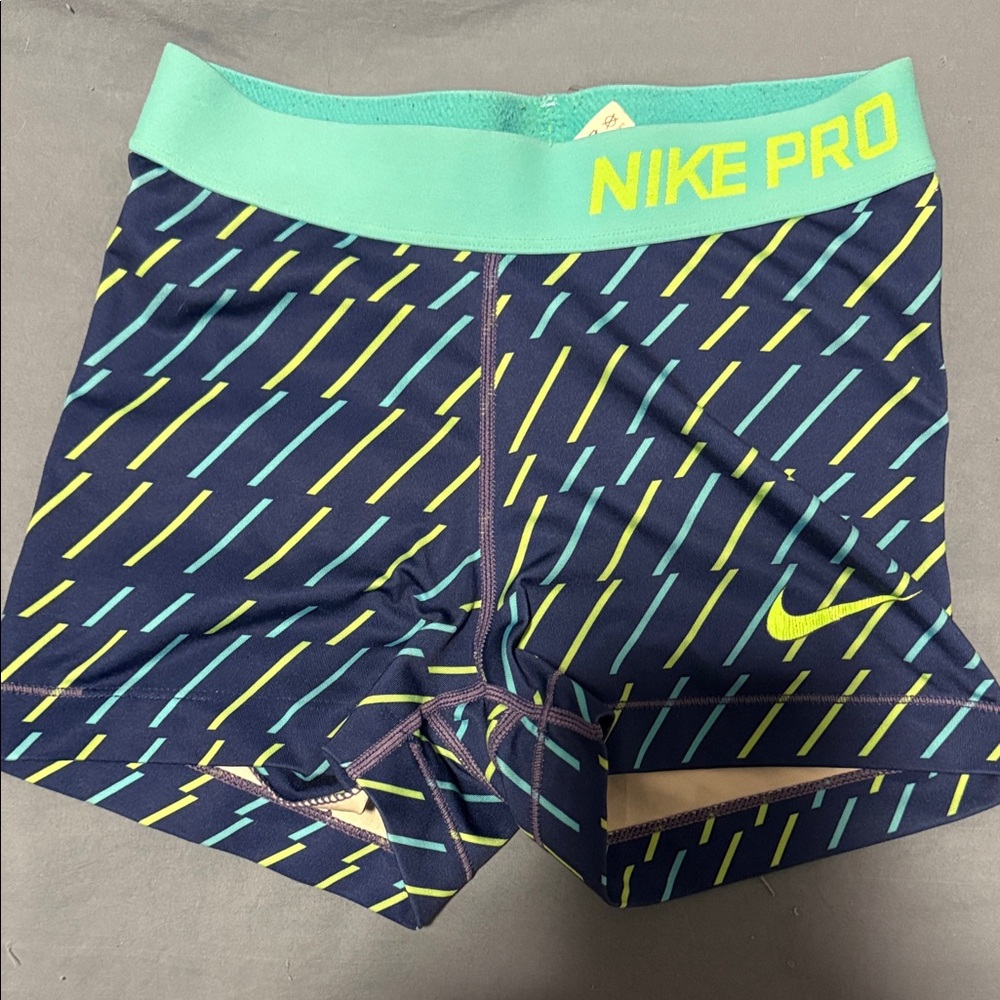 Nike Navy Compression Shorts with Teal Waistband & Neon Yellow Accents
Size XS
